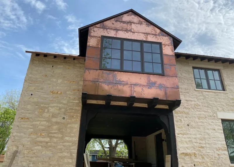 Copper metal panel facade on a stone building for Skylight Installation in Sandpoint